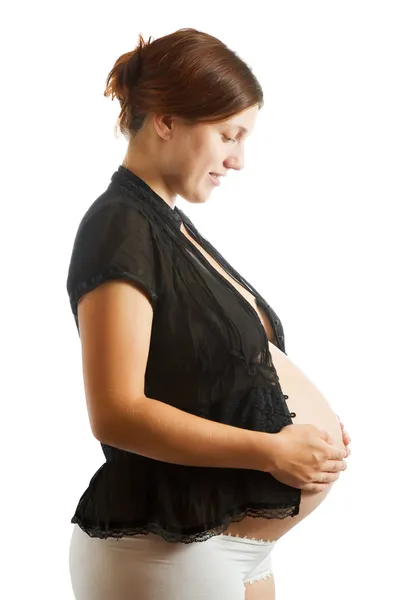 Gravid kvinna i svart tröja över vita — Stockfoto