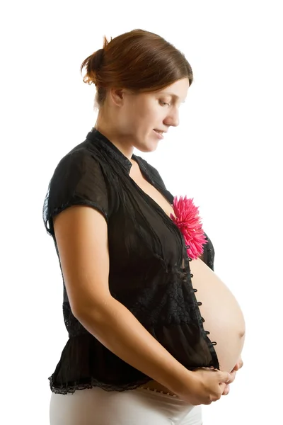 Femme enceinte tenant fleur — Photo