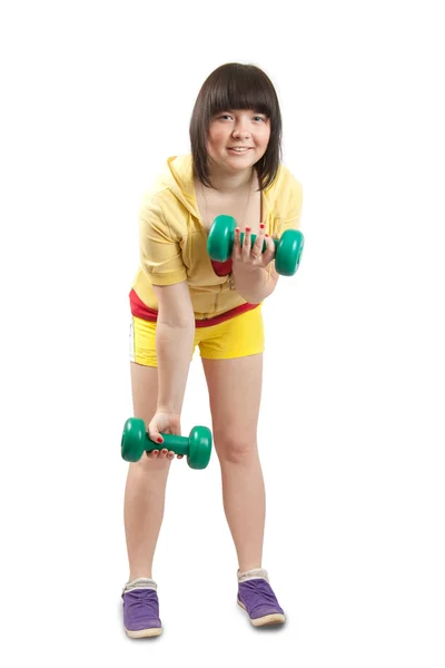 Девушка в жёлтом упражняется с гирями — стоковое фото