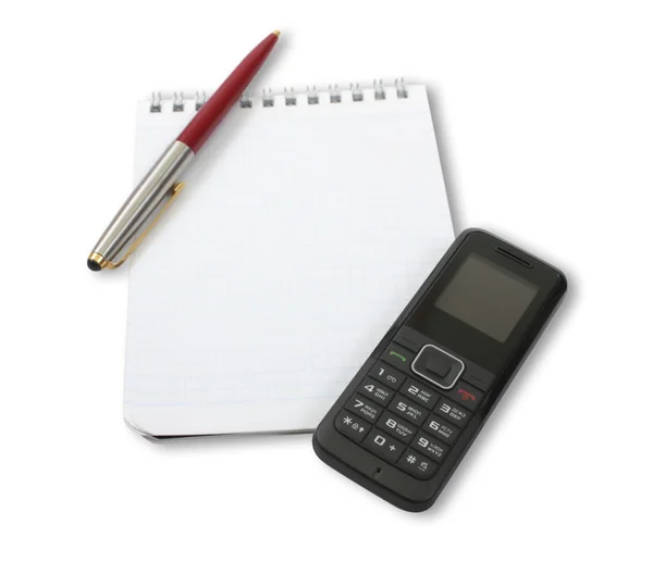 Prázdné notebook s telefonem a pera — Stock fotografie
