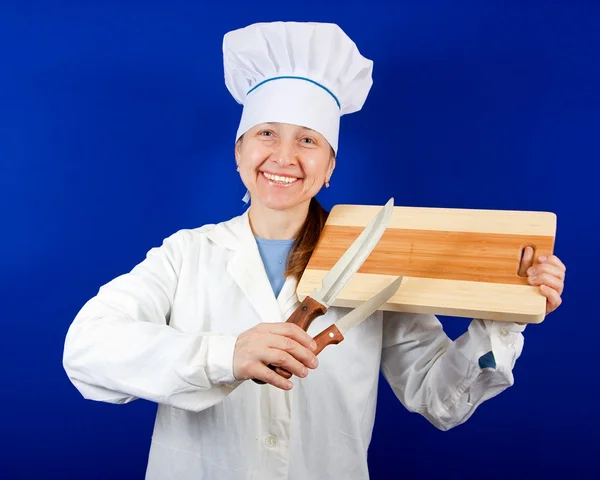 Cook holding cutting board and knives — Stock Photo, Image