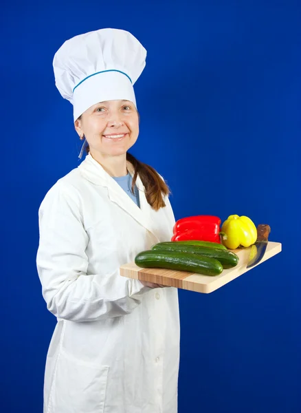 Cook with vegetables and knife — Stock Photo, Image