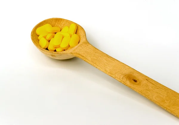 Spoon with tablets — Stock Photo, Image