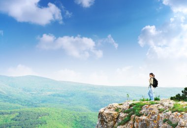 Girl on the peak of mountain clipart