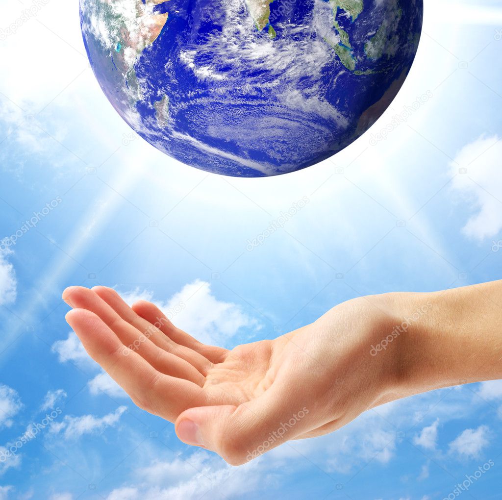 Planet Earth and human hand