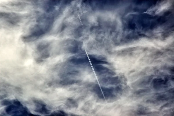 The cloudy sky and vapor trail of two pl — Stock Photo, Image
