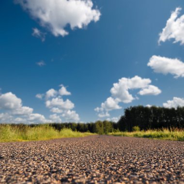 Straight road in rural landscape clipart