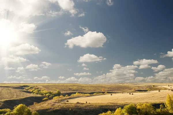 stock image Big sun cloudy blue sky above an autumn landscape