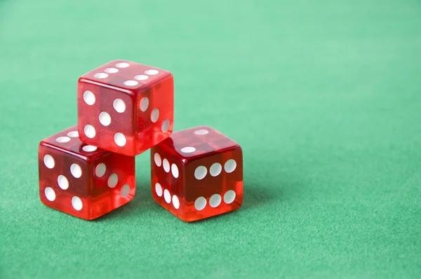 stock image Red dice against green background