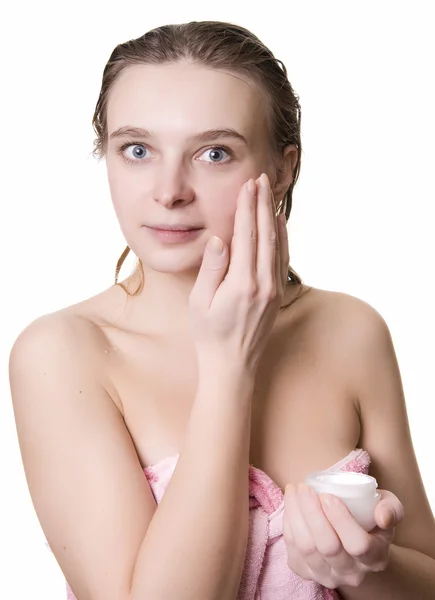 Young beautiful girl applying cream — Stock Photo, Image