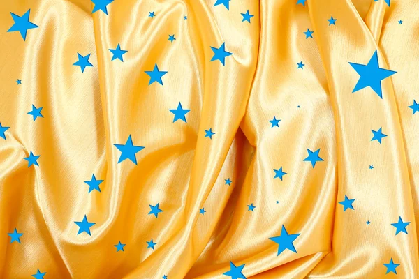 The golden fabric with blue stars — Stock Photo, Image