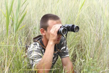 A border war is looking through binoculars clipart