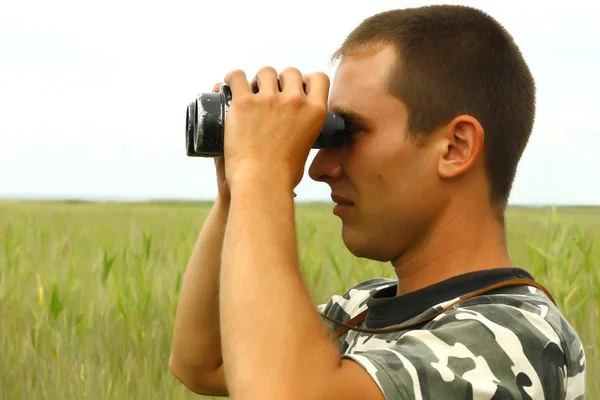 stock image A border war is looking through binoculars