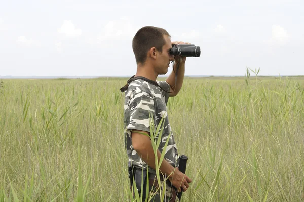 stock image A border war is looking through binoculars