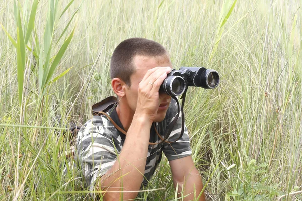 stock image A border war is looking through binoculars