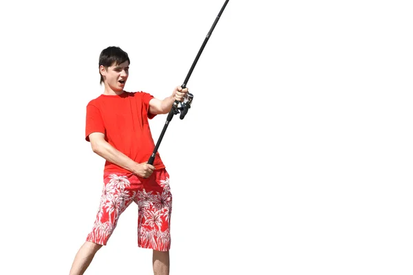 Mladý muž v šortkách a tričku s rybářským prutem — Stock fotografie