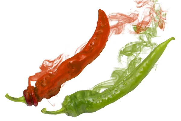 Two red and green peppers with smoke — Stock Photo, Image