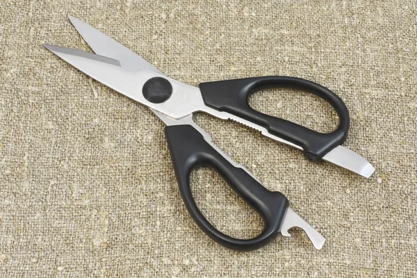 Scissors on the background fabric from matting — Stock Photo, Image