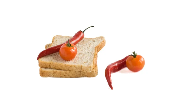 Duas fatias de pães, tomates, pimentas — Fotografia de Stock