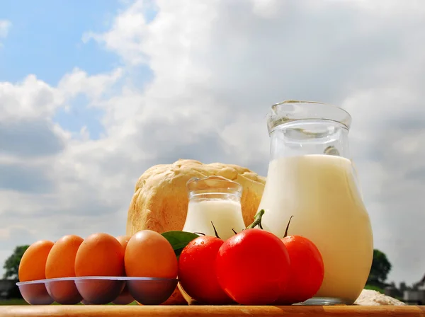 Jug with milk, bread and eggs — Stock Photo, Image