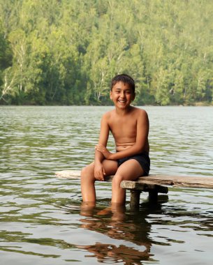 Boy sitting on stage clipart