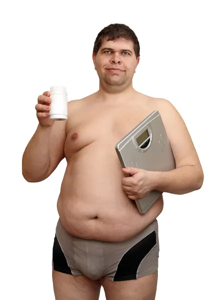 Homem com excesso de peso com medicamentos e balanças — Fotografia de Stock