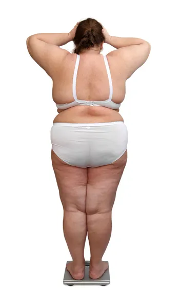 Women with overweight from behind on scales — Stock Photo, Image