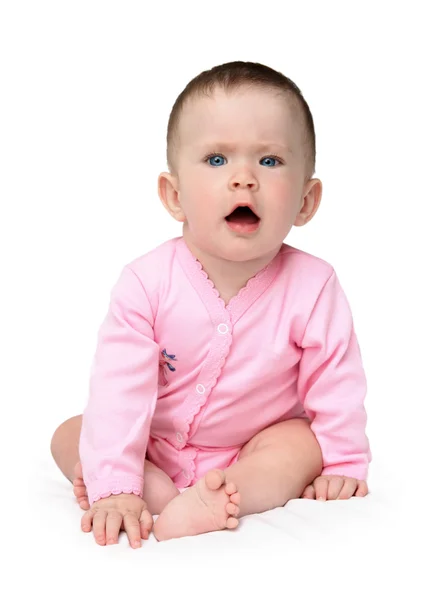 Displeased baby girl sitting — Stock Photo, Image