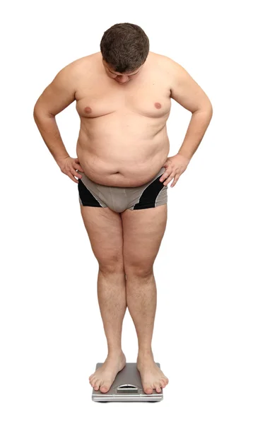 Obézní muž na stupnicích — Stock fotografie