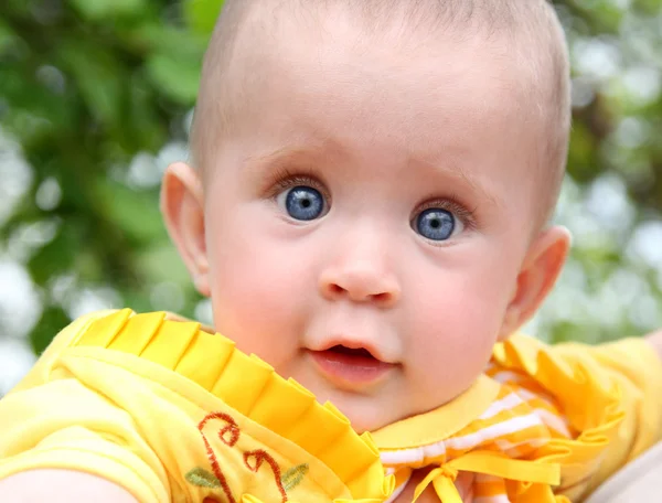 Looking baby in yellow — Stock Photo, Image
