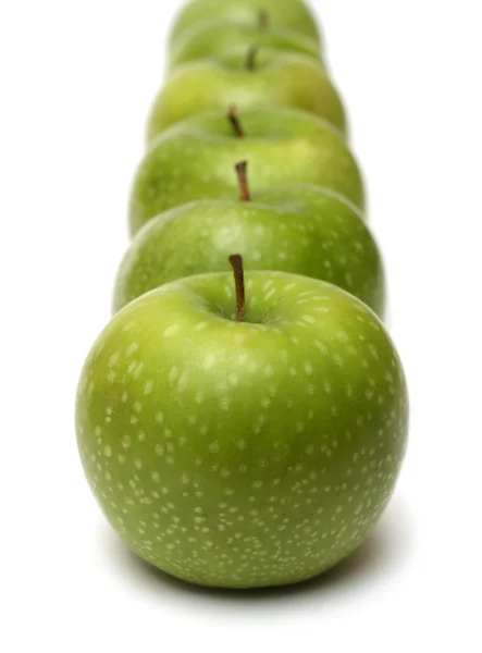 Green apples in row — Stock Photo, Image