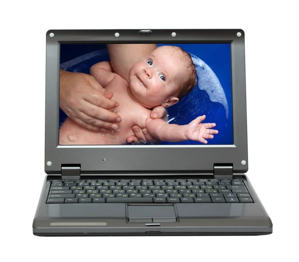Laptop with bathing baby — Stockfoto