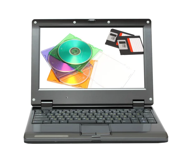 Маленький ноутбук с дисками и дискетами — стоковое фото