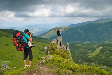 Man in montains is photographing clipart