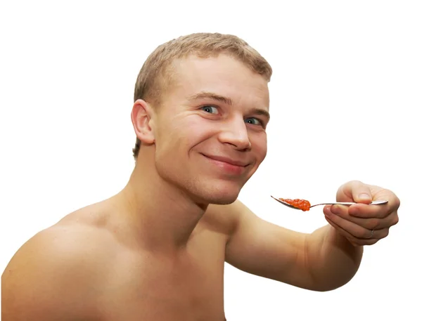 Junger Mann isst roten Kaviar — Stockfoto