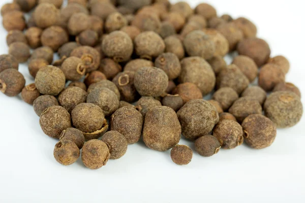 Detail shot of a pile of black peppercorns. All isolated — Stock Photo, Image