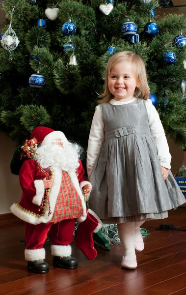 Cute little girl with toy Santa Claus — Stock Photo, Image