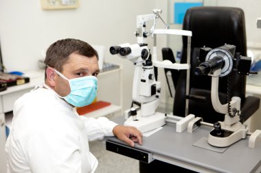 Doctor in ophthalmology clinic clipart