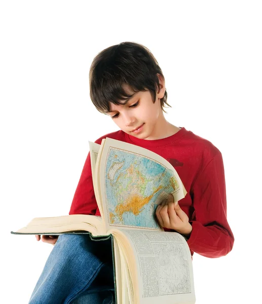 Bonito menino ler um grande livro — Fotografia de Stock