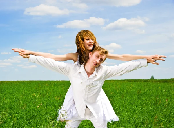 Couple in a green grass — Stock Photo, Image