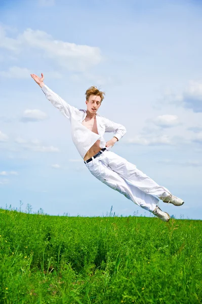 stock image Men jump in the meadow