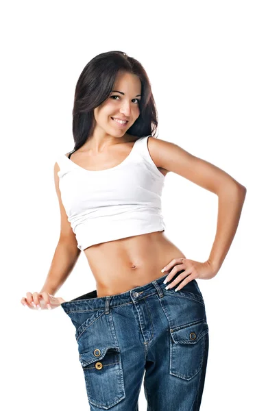 Young girl demonstrating weight loss Stock Photo