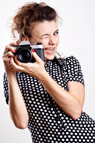 stock image Beautiful woman in a black polka dot dress with camera