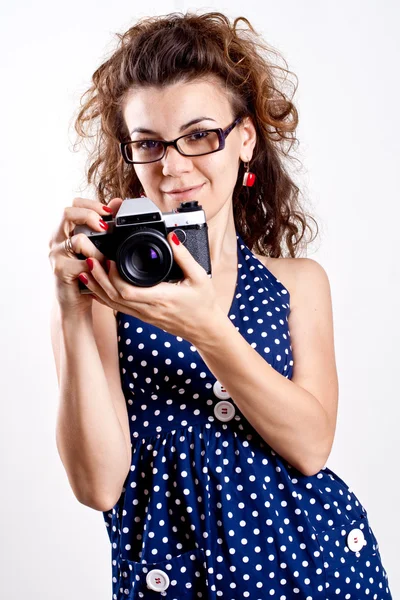 stock image Beautiful woman in a blue polka dot dress with camera