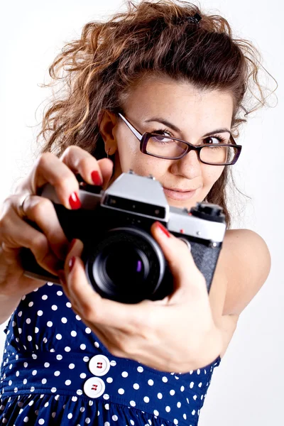 Beautiful woman in a blue polka dot dress with camera — Stock Photo, Image