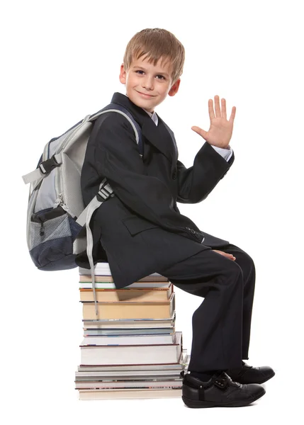 stock image Schoolboy sitting on books