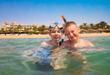 Two boys on a beach clipart