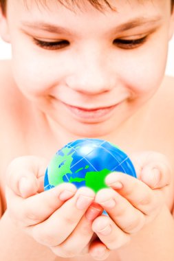 Boy holds globe in hands clipart