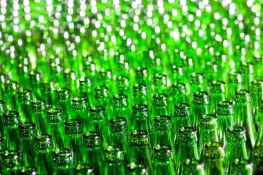 Bunch of green glass bottles. Soft focus. clipart