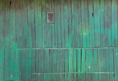 Old wooden wall of a green shade and window clipart